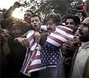 Pakistani demonstrators burn a paper representation of the U.S. flag during a protest against a U.S. consular employee suspected in the shooting deaths of two Pakistani men in Lahore in Islamabad on Friday. AP