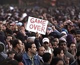 An anti-government protester holds a sign reading 'Game Over' in Tahrir square in downtown Cairo, Egypt, on Saturday. AP