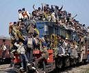 Aspirants travel by an overcrowded train at Badaun railway station on Tuesday as they return after a violence during ITBP recruitment rally in Bareilly. PTI