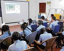 Trendsetters: Students engrossed in an English class, a departure from the conventional blackboard teaching. dh photo