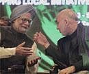 Afghan President Hamid Karzai, right, talks with Prime Minister Manmohan Singh during the 11th Delhi Sustainable Development Summit in New Delhi on Thursday. AP