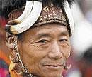 Ethnic pride: Naga dancer with tiger claw necklace and traditional head gear.