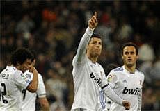 Real Madrid's Cristiano Ronaldo from Portugal, center, reacts after scoring against Real Sociedad with fellow team members Marcelo from Brazil, left, and Ricardo Carvalho from Portugal, right, during a Spanish La Liga soccer match at the Santiago Bernabeu stadium in Madrid, Sunday, Feb. 6, 2011.AP