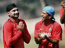 Cricketers Harbhajan Singh and Sachin Tendulkar during a training session ahead of the World Cup Cricket 2011 at Chinnaswamy stadium in Bangalore on Saturday. PTI