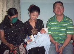 American couple Karren Kim and Thomas with the baby boy 'Brady' born to a surrogate mother (L) in Gujarat. File Photo