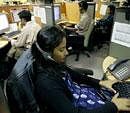 Employees at a call centre provide service support to international customers, in Bangalore. Reuters