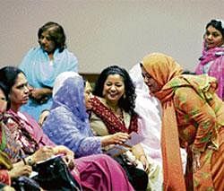 Adapting To The Western World: Mothers chat as their children participate in the Matrimonial Banquet at the Islamic Society of North Americas annual convention in Chicago. NYT