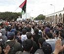 In this photo released by China's Xinhua News Agency, people attend a protest in the eastern Libyan town of Derna on Wednesday. AP