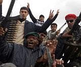 Libyan anti-regime protesters show machineguns and ammunition confiscated from soldiers in Benghazi on Friday. AFP