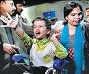 An Indian family, which was evacuated from Tripoli in Libya, arrives at the Indira Gandhi International airport, in New Delhi, on Sunday. AP