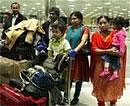 Indians living in Libya upon their arrival at IGI airport in New Delhi on late Saturday. PTI