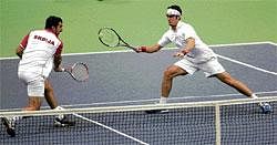 Big Win: Serbia's Ilija Bozoljac (right) returns as team-mate Nenad Zimonjic looks on during their Davis Cup match against  Indias Rohan Bopanna and Somdev Devvarman in Novi Sad on Saturday. AP