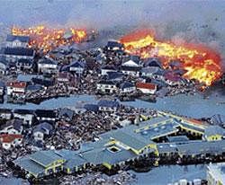 Apocalypse now: Houses are in flames while the Natori river is flooded over the surrounding area by tsunami tidal waves in Natori city, Miyagi Prefecture, northern Japan, on Friday, after strong earthquakes rocked the region.  AP