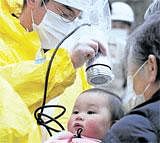 TIMELY CARE A baby is checked for radiation exposure level in Nihonmatsu in Fukushima on Tuesday, following a third explosion at the Fukushima Dai-ichi nuclear power complex. AP
