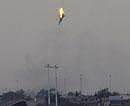 A warplane of Gadhafi's  forces is seen being shot down over the outskirts of Benghazi, eastern Libya, on Saturday. AP