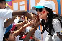 Bollywood actress Yana Gupta being applied colour by children during Holi celebrations in Mumbai on Friday. PTI