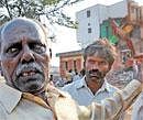 Former corporator Ishwar Rao points at his demolished house. DH photo