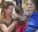 Microsoft Corp. founder and philanthropist Bill Gates, right, and his wife Melinda Gates attend to a child as they meet with members of the Mushar community at Jamsot Village near Patna on Wednesday. AP