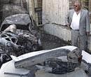 An Iraqi man inspects the scene of a rocket attack in Baghdad, Iraq on Tuesday. AP Photo