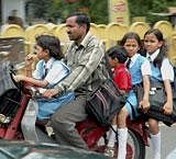 A man carries his children on a two wheeler in Bhopal . A file PTI Photo