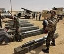 Libyan rebel fighters prepare rockets for use at a position west of Ajdabiya, Libya, Wednesday, April 6, 2011. AP