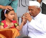Social activist Anna Hazare being offered lemon water by a little girl to break his fast-unto-death for Jan Lokpal Bill at Jantar Mantar in New Delhi on Saturday. PTI