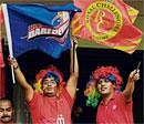 Enjoying: Fans show their love for the game by wearing colourful wigs.