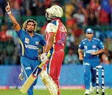 IN TOP FORM: Mumbai Indians Lasith Malinga celebrates after cleaning up Royal Challengers Bangalores Mayank Agarwal in an IPL match in Bangalore on Tuesday. DH PHOTO/ SRIKANTA&#8200;SHARMA&#8200;R