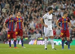 Real Madrid's  Cristiano Ronaldo from Portugal, second right, and Barcelona's  Lionel Messi from Argentina, left, Sergio Busquets, second, left, and  Afellay from the Netherlands, right, react during their Spanish La Liga soccer match at the Santiago Bernabeu stadium in Madrid, Saturday, April 16, 2011. AP