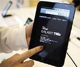 An employee of Samsung Electronics demonstrates Samsung's Galaxy Tab tablet. Reuters file photo