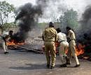 Police try to control fire during a protest against the Jaitapur nuclear power plant in Ratnagiri, Maharashtra on Tuesday. PTI