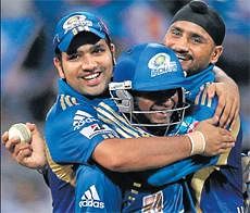On a roll: Mumbai Indians' Harbhajan Singh celebrates with Rohit Sharma (left) and Ambati Rayudu after scalping five wickets in their match against Chennai Super Kings at the Wankhede stadium in Mumbai on Friday. PTI