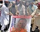 Activists of a local social group Muthahida Shehri Mahaz, burn a banner depicting U.S. President Barack Obama, during a rally to condemn the killing of al-Qaida leader Osama bin Laden, in Multan, Pakistan on Sunday. AP Photo