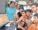 Students of APS Evening PUCollege check results on the internet in Bangalore on Tuesday. DH PHOTO