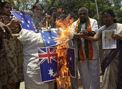Activists of  Bharatiya Janata Party (BJP) burn Australian flags and an effigy in Hyderabad on Friday, May 6, 2011 as they protest against Australian fashion designer Lisa Blue's swimwear creations that featured images of Hindu goddess Lakshmi at the Australian Fashion Week. AP File Photo