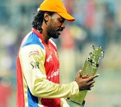 RCB's Chris Gayle with his man of the match trophy in the IPL Twenty-20 match against KKR at Chinnaswamy stadium in Bangalore on Saturday. Photo DHNS