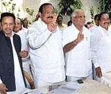 Karnataka Chief Minister B.S Yeddyurappa with senior BJP leader M Venkaiah Naidu showing victory signs during a meeting with party MLAs at the CM's Race Course residence in Bangalore on Monday. PTI Photo