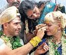 Indian touch: Mathew Ryan with Linah during their marriage at a temple atop Chamundi Hills in Mysore on Wednesday. DH Photo