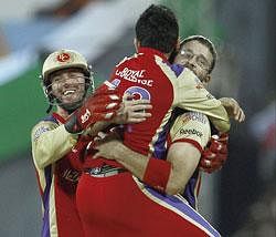Royal Challengers Bangalore skipper Daniel Vettori (right) celebrates with AB de Villiers (left) and Virat Kohli after picking a wicket in their Qualifier 2 match against Mumbai Indians at the MA Chidambaram stadium on Friday. AP