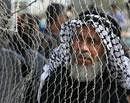 A Palestinian man waits before crossing into Egypt through the Rafah border crossing, southern Gaza Strip, Thursday. AP