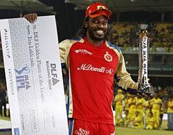 Royal Challengers Bangalore's Chris Gayle poses with the trophy of Highest Run Getter of the tournament after Chennai Super Kings won the Indian Premier League final cricket match in Chennai on Saturday. AP