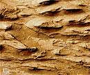 message from mars Images from Mariner 9 in 1972 such as this one, revealed that some of the mesas and mounds found within the chasms of the Martian Grand Canyon, the Valles Marineris, have layers in them. Photo: NASA
