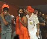 Yoga guru Baba Ramdev with his supporters after clash between police and his supporters broke out during the first day of his Satyagrah against corruption at Ramlila Maidan in New Delhi on Saturday night. PTI