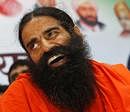 Indian yoga guru Baba Ramdev smiles during a press conference at his ashram in Haridwar. AP