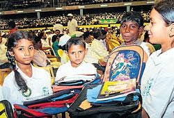 back to school: Child labourers receive study material at a programme organised by the Labour Department to mark World Anti-Child Labour Day in the City on Sunday. dh Photo