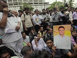 Indian journalists hold a photograph of Jay Dey, a well-known investigative journalist who was gunned down Saturday by assailants, as they protest his killing in Mumbai, India, Monday, June 13, 2011. Jay Dey was known for his reporting on Mumbai's underworld and had worked as investigative editor for the city's Mid-Day newspaper for more than 15 years, the paper said. AP Photo