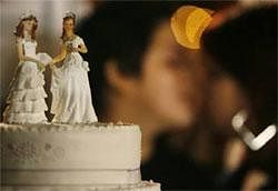 A gay couple kisses next to their wedding cake during a symbolic group wedding on Valentine's Day in Lima February 14, 2011. Reuters File Photo
