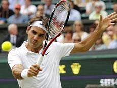 Switzerland's Roger Federer returns a backhand shot to Argentina's David Nalbandian during their match at the All England Lawn Tennis Championships at Wimbledon, Saturday.AP