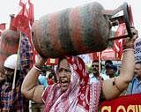 People carrying LPG cylinder during a protest against hike in fuel prices in Bhubaneswar on Saturday. PTI