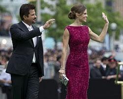 Anil Kapoor and Hilary Swank wave to fans as they arrive on the green carpet at the 2011 International Indian Film Academy Awards, Saturday, June 25, 2011, in Toronto. AP